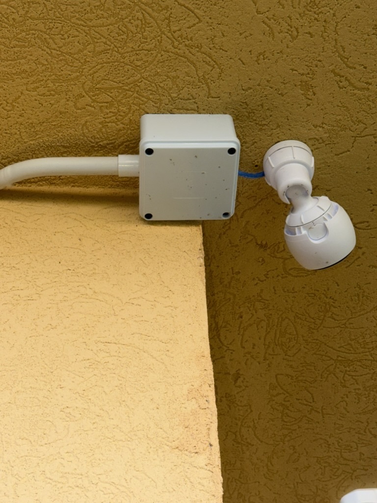 UniFi G3 Instant camera with junction box and conduit on exterior wall